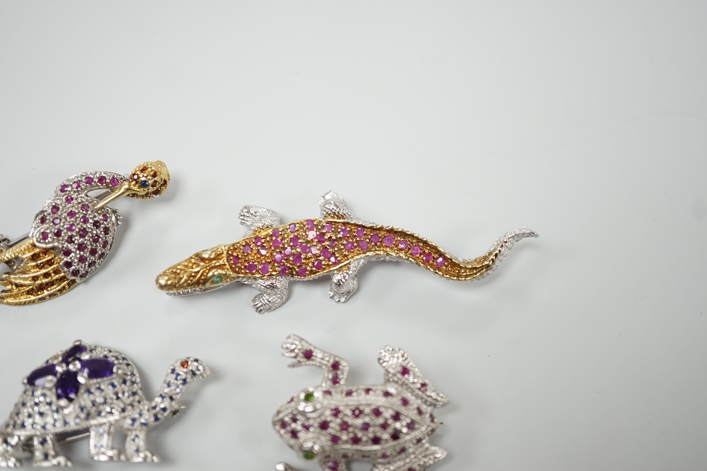 Four assorted modern white metal and coloured paste set miniature animal brooches, three stamped 925, including frog, crane, tortoise and crocodile.